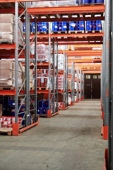 Oferta Industrial warehouse interior with organized shelves stacked with packages and goods.